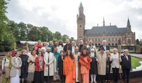 Interfaith leaders standing together in front of the International Peace Palace, The Hague